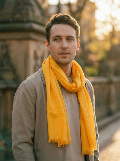 Man wearing Sunglow Orange Moroccan Tagelmust as a breathable desert headscarf, lightweight safari scarf built for Sahara trekking, dust protection, and hot weather overlanding.