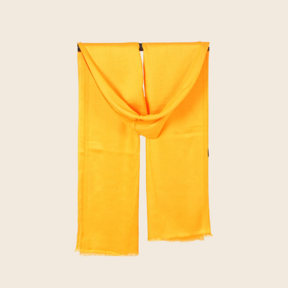 Yellow scarf draped over a beige background