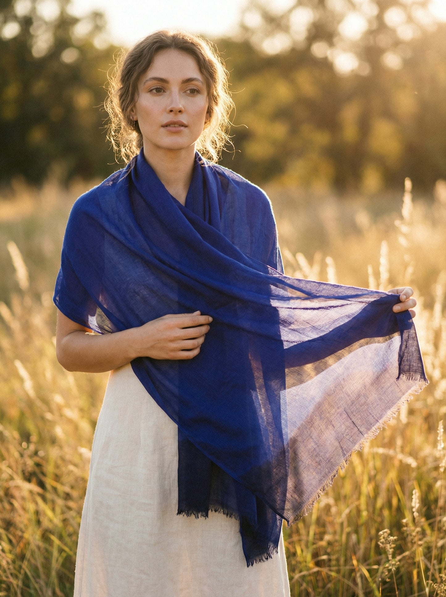 Indigo blue Tagelmust styled as a lightweight travel scarf for women, Touareg inspired Moroccan headscarf ideal for hot climate safari and sun protection.