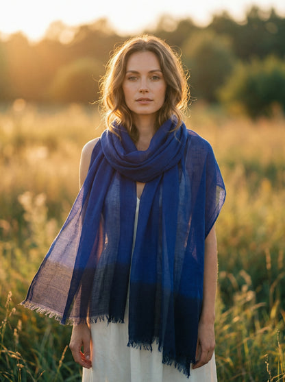 Indigo blue Tagelmust styled as a lightweight travel scarf for women, Touareg inspired Moroccan headscarf ideal for hot climate safari and sun protection.
