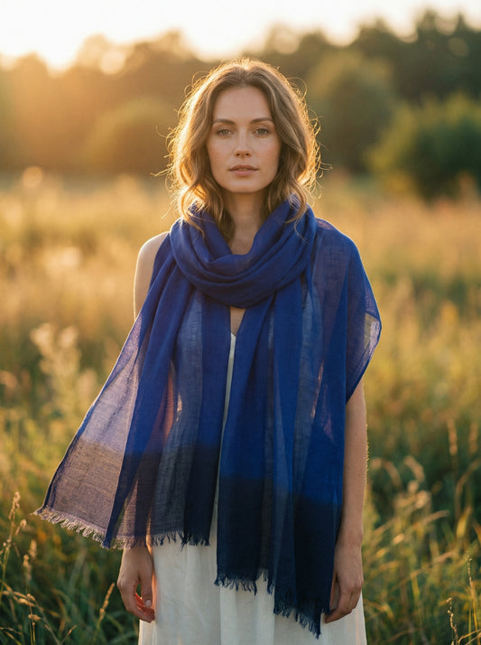 Indigo blue Tagelmust styled as a lightweight travel scarf for women, Touareg inspired Moroccan headscarf ideal for hot climate safari and sun protection.