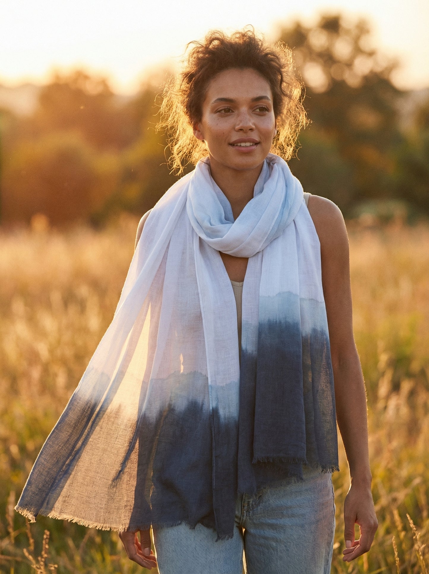 White Tagelmust styled as a lightweight travel scarf for women, Touareg inspired Moroccan headscarf perfect for hot climate exploration.