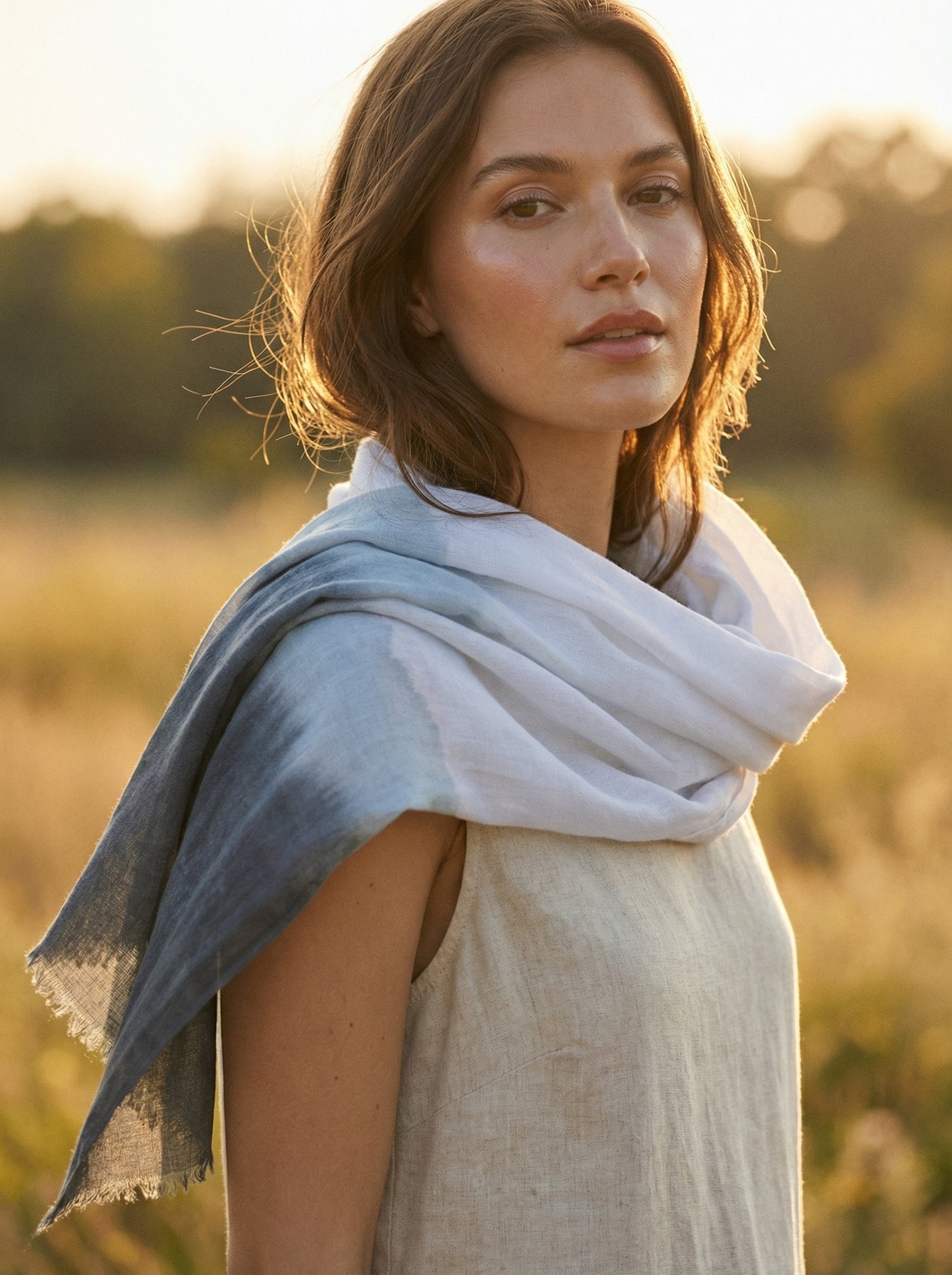 White Tagelmust styled as a lightweight travel scarf for women, Touareg inspired Moroccan headscarf perfect for hot climate exploration.