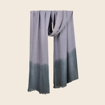 Cinerous Gray Soaked Tagelmust scarf – slate‑grey hanging wrap fading to muted teal gradient. Sustainably sourced lightweight Moroccan headscarf, ideal for nomadic travelers searching for grey or teal scarves for hot‑weather, dry‑climate adventures.