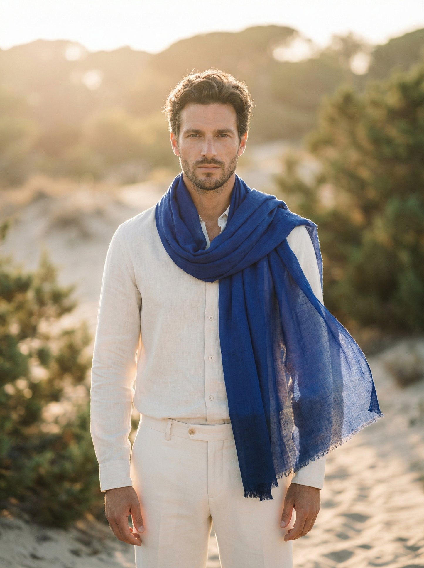 Man wearing indigo Moroccan Tagelmust as a breathable desert headscarf, lightweight safari scarf built for Sahara trekking and dust protection.