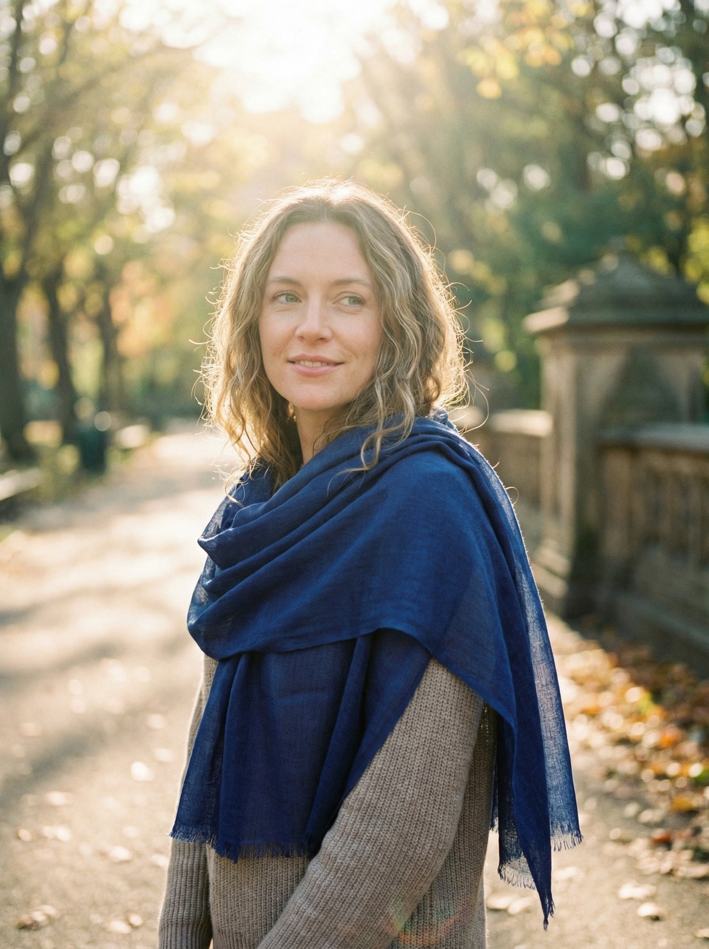Indigo blue Tagelmust styled as a lightweight travel scarf for women, Touareg inspired Moroccan headscarf ideal for hot climate safari and sun protection.