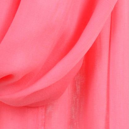 Close‑up of Rose Pompadour Soaked Tagelmust scarf fabric – vivid coral‑pink Moroccan headscarf, sustainably sourced lightweight weave ideal for nomadic travelers searching for pink scarves for hot‑weather, dry‑climate adventures.