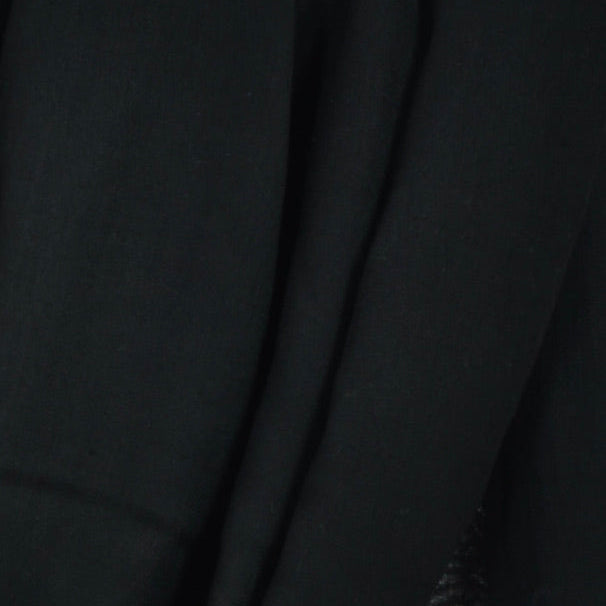 Close‑up of Smoke Black Original Tagelmust scarf fabric – rich deep black Moroccan headscarf, sustainably sourced lightweight weave ideal for nomadic travelers searching for pure black scarves for hot‑weather, dry‑climate adventures.